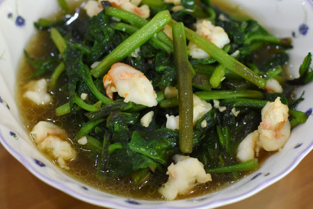 Stir-fried Chinese kale with shrimps in white bowl