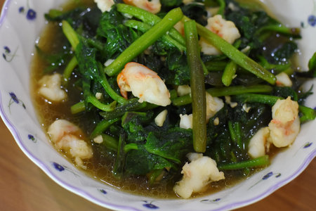 stir-fried kale with prawns in a bowl.