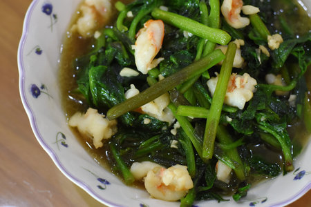 stir-fried kale with shrimps in a bowl.