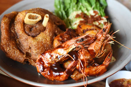 Fried prawns on the plate with sauce and salad.の写真素材