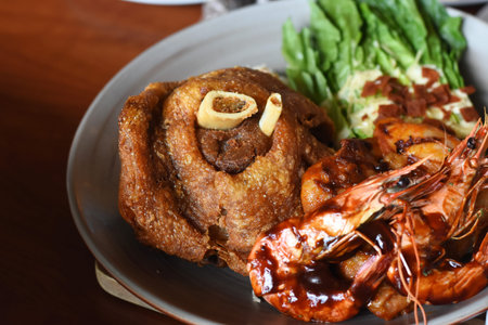 Fried pork with prawns on the plate in the restaurant