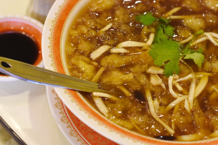 Chinese soup with pork and vegetable in a bowl, close up.の写真素材