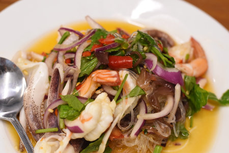 Thai spicy seafood salad with shrimp, squid, mussel, squidの写真素材