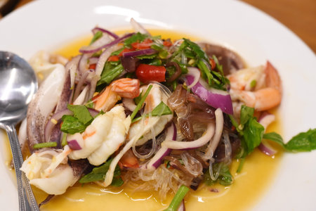 Seafood salad with shrimps, squid, mussels and herbsの写真素材