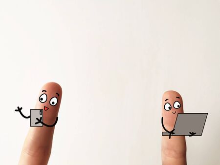 Two fingers are decorated as two person. They are having online meeting at home.の写真素材