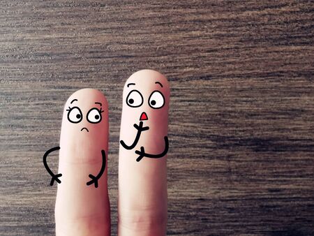 Two fingers are decorated as two person. One of them is suffering from frozen shoulder.の写真素材