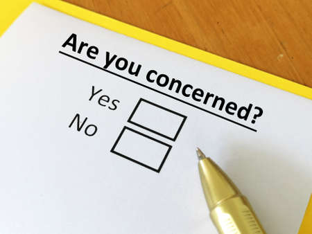 One person is answering question. He is thinking if he is concerned about the social issues.の写真素材
