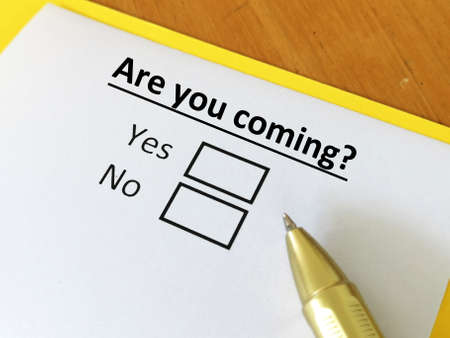 One person is answering question. He is thinking if he can attend an event.の写真素材