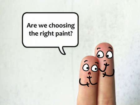 Two fingers are decorated as two person. They are discussing about problems of building. One of them is asking if they are choosing the right paint.の写真素材