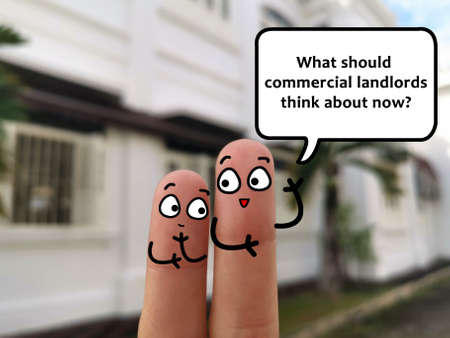 Two fingers are decorated as two person. They are discussing about what concern of commercial landlords.の写真素材