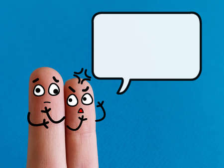 Two fingers are decorated as two person. One of them is scolding his friend who is a disabled.の写真素材