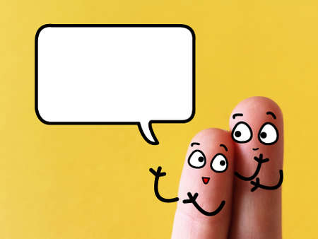 Two fingers are decorated as two person. They are talking to each other.の写真素材