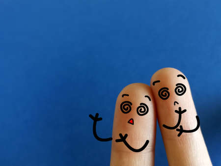 Two fingers are decorated as two person. They are confused.の写真素材