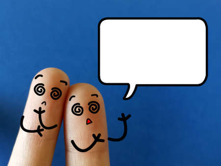 Two fingers are decorated as two person. They are confused.の写真素材