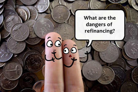 Two fingers are decorated as two person. They are discussing about business. They are discussing about the dangers of refinancing.の写真素材