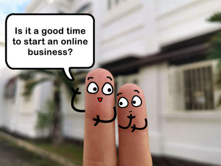 Two fingers are decorated as two person. They are discussing about starting online business.の写真素材