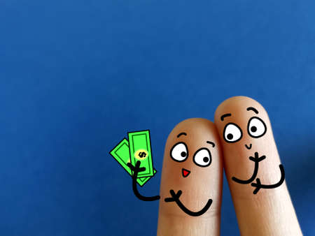 Two fingers are decorated as two person. One of them has extra money. They are thinking about what to buy with the money they have.の写真素材