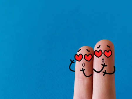 Two fingers are decorated as two person. They are in love with certain products.の写真素材
