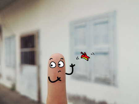 One finger is decorated as a person at the backyard. The person is throwing rubbish on the floor.の写真素材
