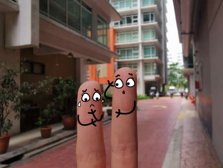Two fingers are decorated as two person. One of them is suffering from depression.の写真素材