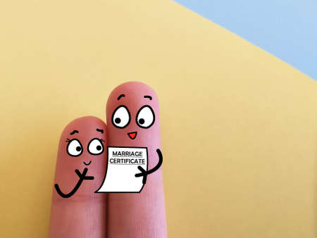 Two fingers are decorated as two person. They just got married.の写真素材