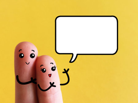 Two fingers are decorated as two person. They are discussing about something happily.の写真素材