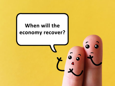 Two fingers are decorated as two person. One of them is asking another when will the economy recover.の写真素材