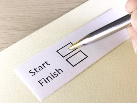 One person is answering question on a piece of paper. The person is thinking to start or to finish.