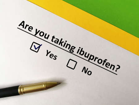 One person is answering question. He is taking ibuprofen.の写真素材