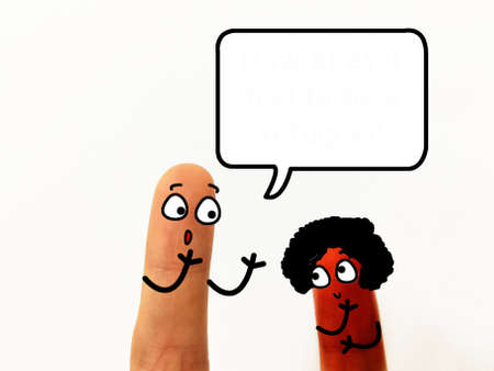 Two fingers are decorated as two person. They have different skin color.の写真素材
