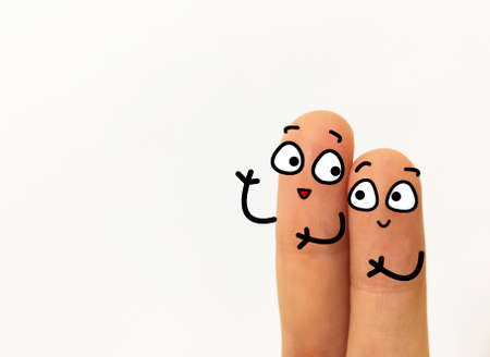 Two fingers are decorated as two person. One of them is asking  another question.の写真素材