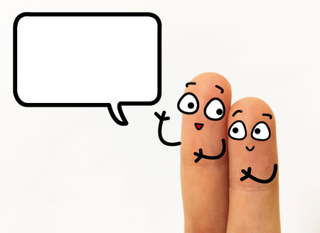 Two fingers are decorated as two person. One of them is asking  another question.の写真素材