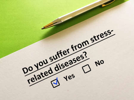 One person is answering question. The person thinks that he is suffering from stress related diseases.の写真素材