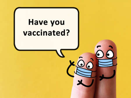 Two fingers are decorated as two person. One of them is asking  if you have vaccinated.の写真素材
