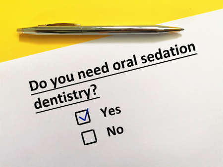 One person is answering question about dental procedure. He needs oral sedation dentistry.の写真素材