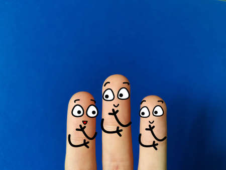Three fingers are decorated as three person. They are happily discussing about a planの写真素材