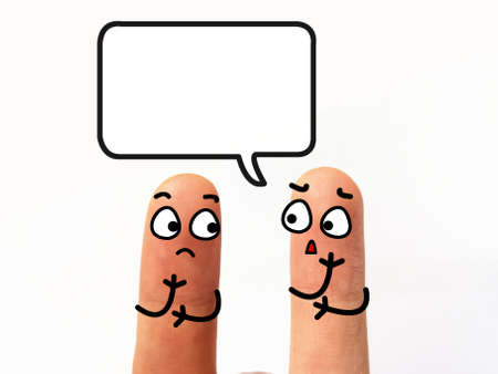 Two fingers are decorated as two person. Both of them are worrying about problems.の写真素材