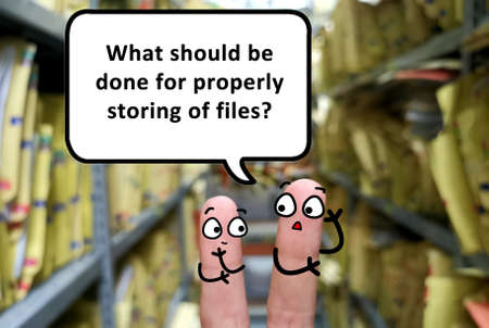 Two fingers are decorated as two person discussing about filing problem. One of them is asking what should be done for properly storing of files.の写真素材