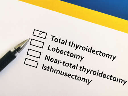 One person is answering question about thyroid pathology.The person chooses total thyroidectomy.の写真素材