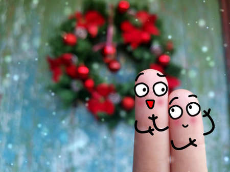 Two fingers are decorated as two person. They are happy.の写真素材