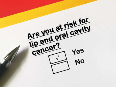 One person is answering question about cancer risk. He is at risk for lip and oral cavity cancer.の写真素材
