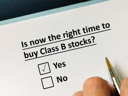 One person is answering question about investment. He thinks it  is now the right time to buy class B stocks.の写真素材