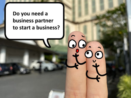 Two fingers are decorated as two person. One of them is asking another if he needs business partner to start a business.の写真素材