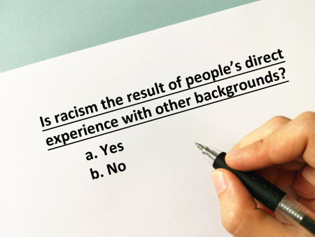 One person is answering question about racism. He is thinking if racism is the result of people's direct experience with other backgrounds.の写真素材