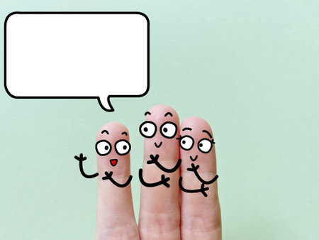 Three fingers are decorated as three person. One of them is talking.の写真素材