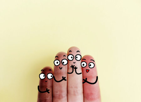 Four fingers are decorated as four person. They are from different places with different skin color and they are happy to be together.の写真素材