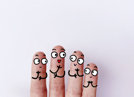 Four fingers are decorated as four person. They are happy.の写真素材