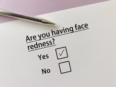 A person is answering question about skin problem. He is having face redness.の写真素材