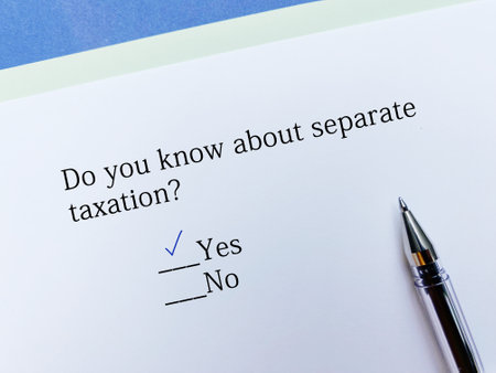 A person is answering question about taxation. He knows about separate taxation.の写真素材