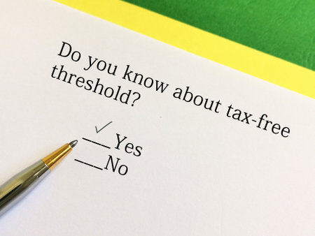 A person is answering question about taxation. He knows about tax free thresholdの写真素材